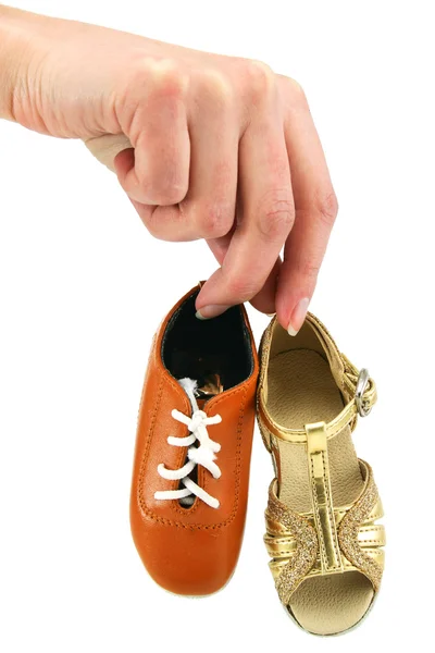 Female hand holds tiny dancing shoes — Stock Photo, Image