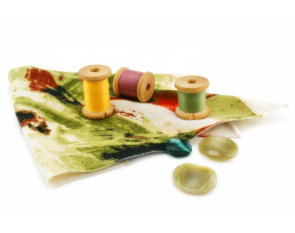 Шматок тканини, кольорові нитки і приклад — стокове фото
