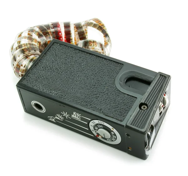 Small espionage photo camera and film — Stock Photo, Image