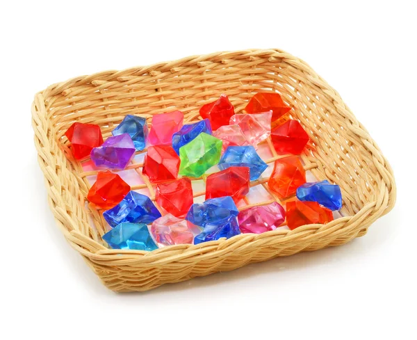 stock image Colored assorted gemstones in wooden basket isol