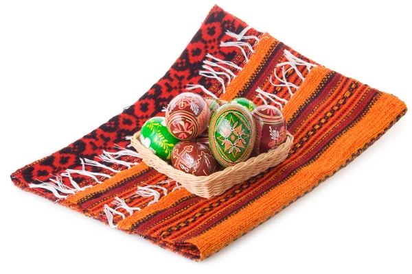 Painted Easter eggs in basket on towel — Stock Photo, Image