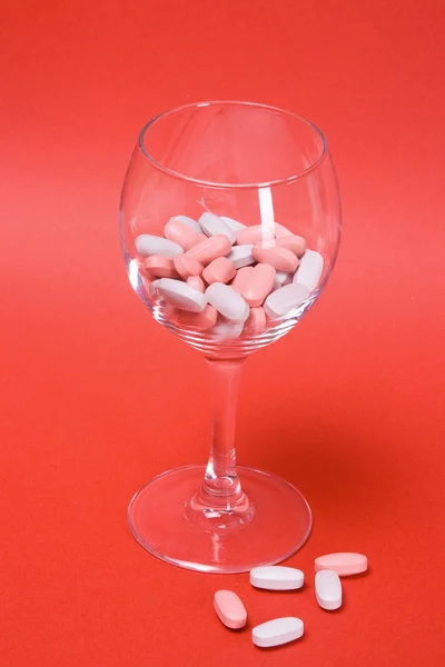 Heap of oval tablets in glass — Stock Photo, Image