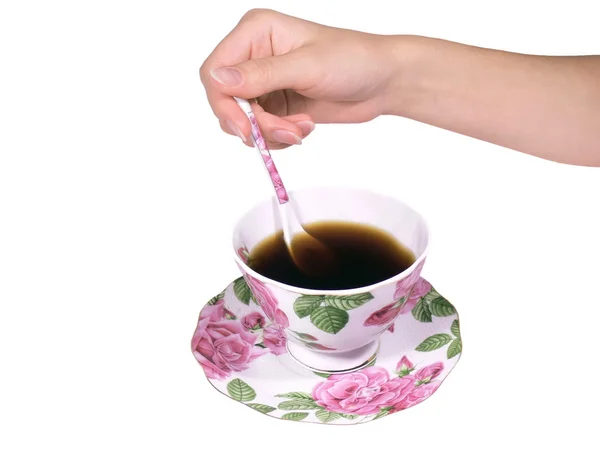 stock image The female hand a spoon stirs tea