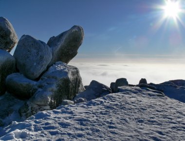 Big stones on top of mountain at winter clipart