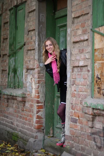 Het meisje in de buurt van het oude huis — Stockfoto