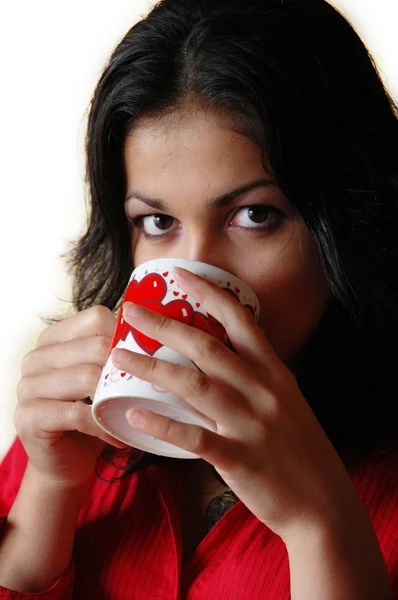 Beautiful woman drinks from a mug — Stock Photo, Image