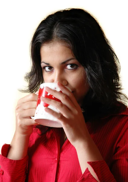 Brunette woman drinks from a mug — Stock Photo, Image