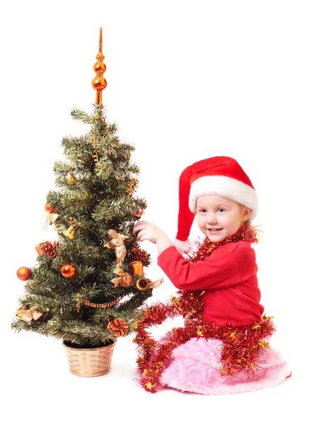 Kind mit roten Weihnachtsmützen — Stockfoto