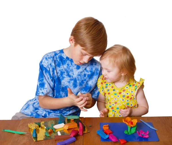 Boy and girl with plasticine — Stock Photo, Image