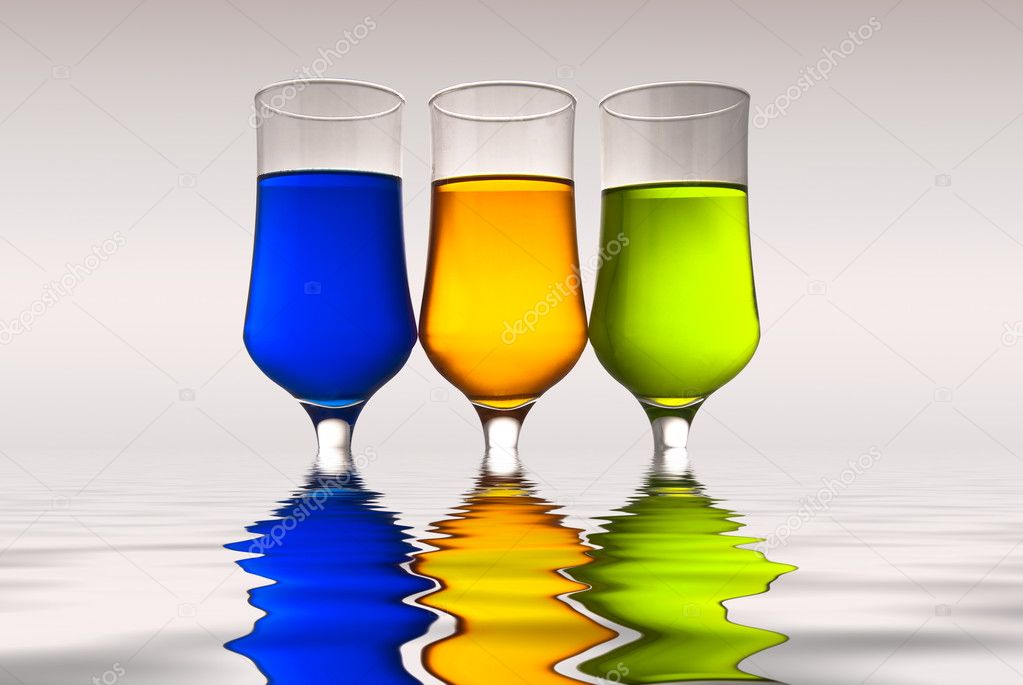 Glasses with multi-coloured drinks and r