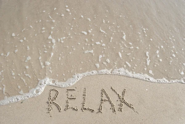 Inscription Relax on a sand and a wave — Stock Photo, Image