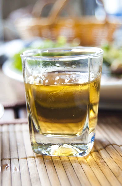 Glass with an alcoholic drink on the ser — Stock Photo, Image