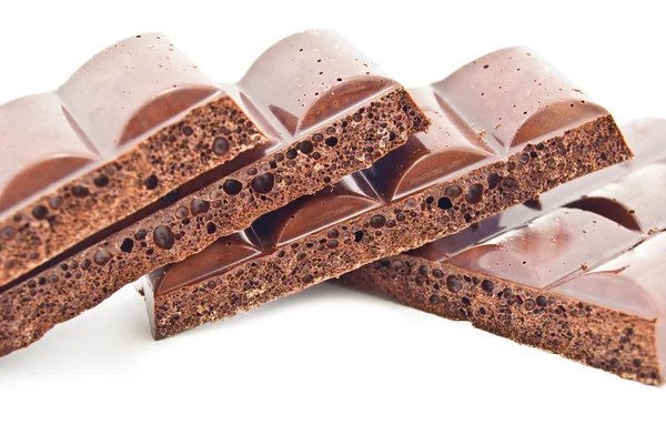 Some slices of black porous chocolate — Stock Photo, Image