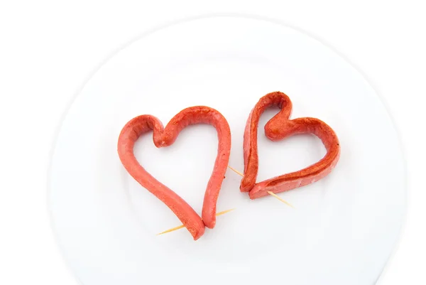 Dos salchichas fritas en forma de corazón —  Fotos de Stock