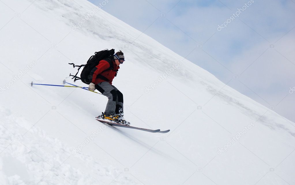 Skier running down