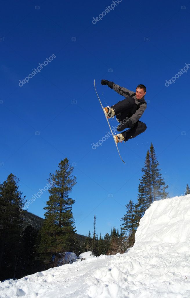 Gray snowboarder jumping high