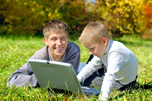 Brothers with notebook — Stock Photo, Image