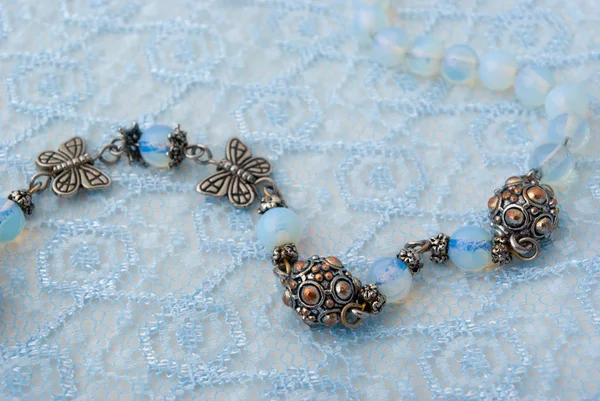 stock image Blue beads on blue lace