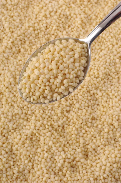 Couscous on spoon — Stock Photo, Image