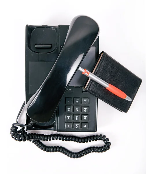 Notebook and a telephone — Stockfoto