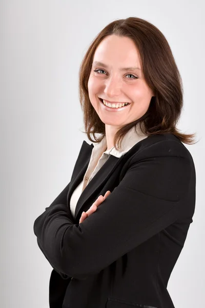 Mujer de negocios sonriente en gris —  Fotos de Stock
