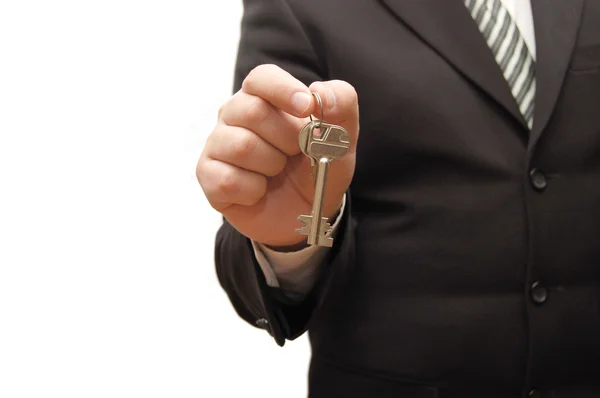 Uomo d'affari mano, tenendo la chiave — Foto Stock