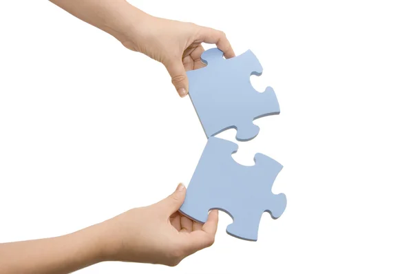 Hand collecting a part of a puzzle — Stock Photo, Image