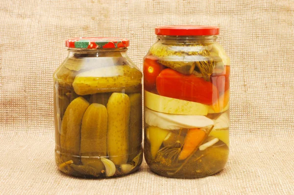 Jars with tinned vegetables on a sacking — Stock Photo, Image