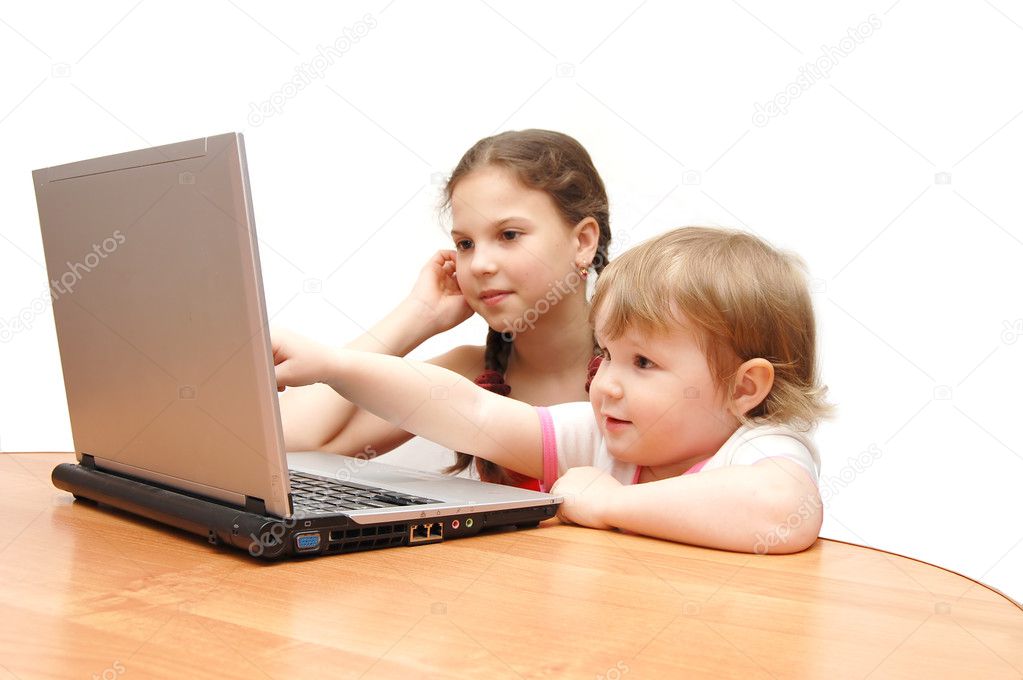 Two little girls behind the laptop