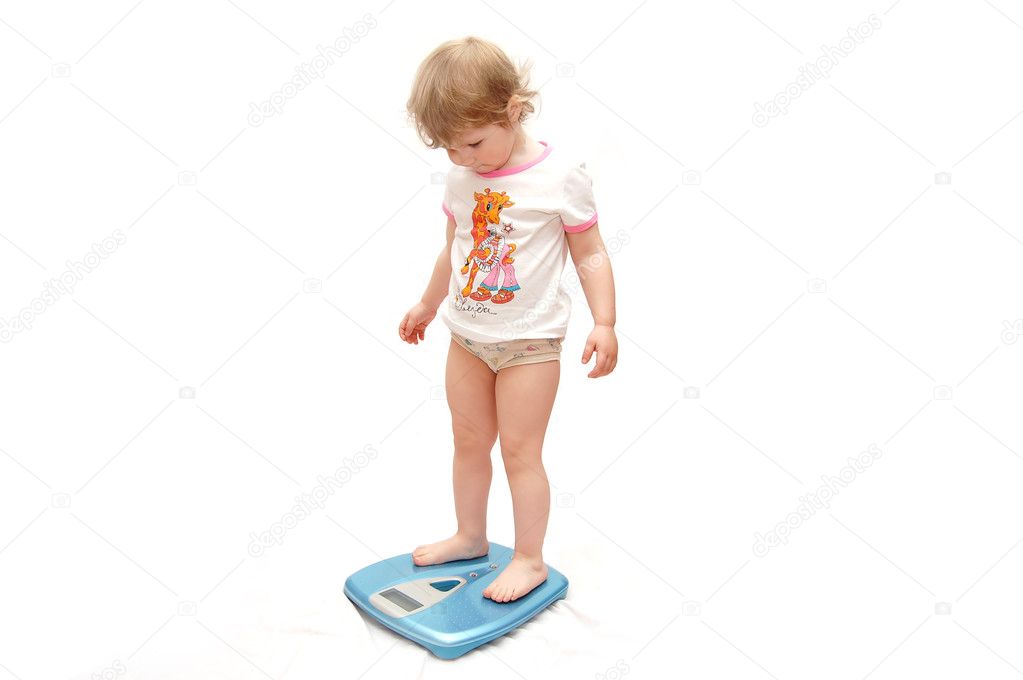 The little girl measures the weight