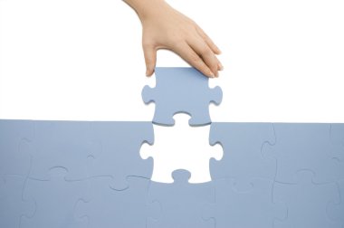 Hand collecting a part of a puzzle clipart