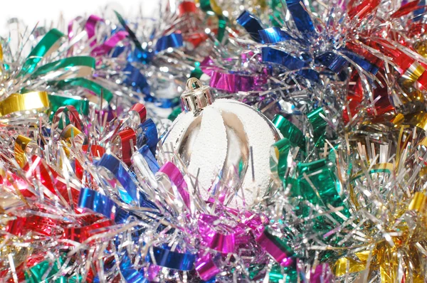 Christmas tinsel with a white toy — Stock Photo, Image