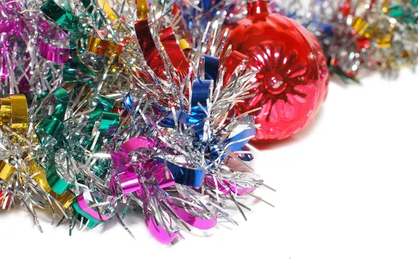 Christmas tinsel with a red toy — Stock Photo, Image