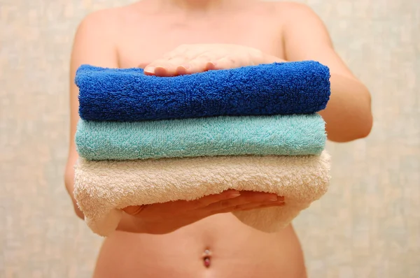 Female hands hold towels — Stock Photo, Image
