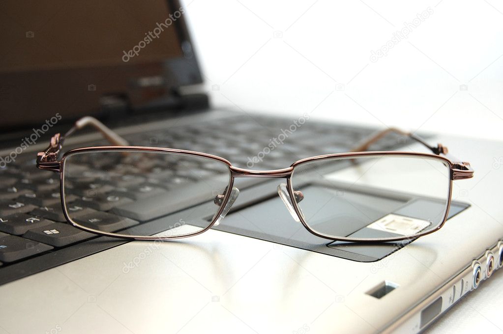 Close up Eyeglasses on the laptop