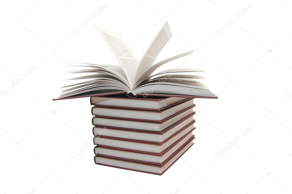 Pile of books with one book open