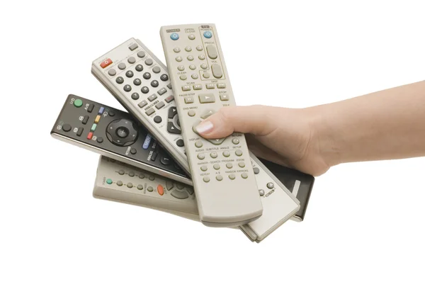Cuatro mando a distancia en una mano aislada —  Fotos de Stock