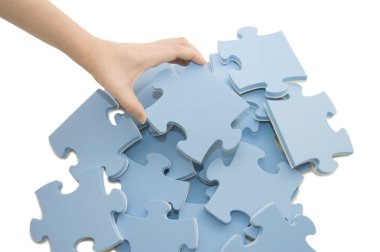 Hand collecting a part of a puzzle clipart