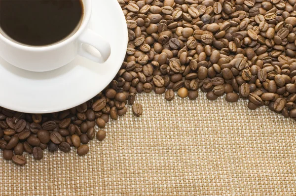 Cup from coffee on coffee grains — Stock Photo, Image