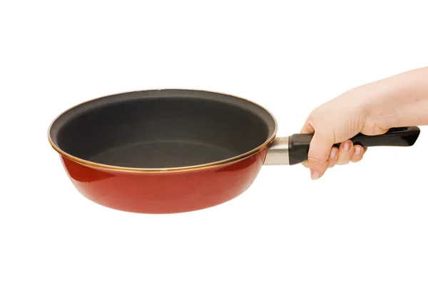 Panela de ato de fritar vermelha em uma mão isolada — Fotografia de Stock