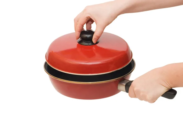 Panela de ato de fritar vermelha em uma mão isolada — Fotografia de Stock