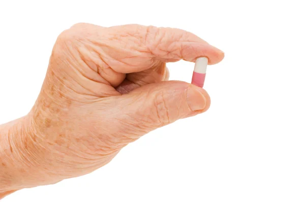Vanhempi käsi tablettien kanssa — kuvapankkivalokuva