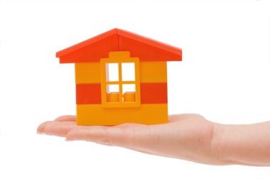 Hand and toy house isolated clipart