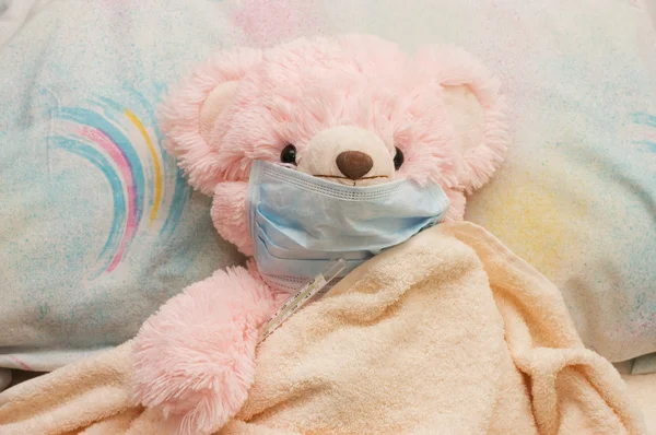 Pink bear is ill in a bed — Stock Photo, Image