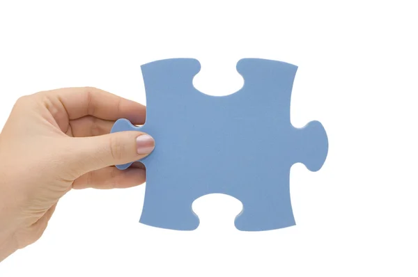 Hand sammelt ein Teil eines Puzzles — Stockfoto