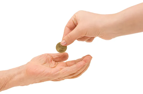 Jonge en oude hand met een munt — Stockfoto