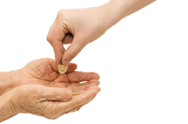 Mão jovem e velha com uma moeda — Fotografia de Stock
