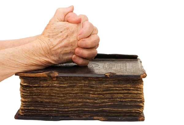 Old female hands on the bible — Stock Photo, Image