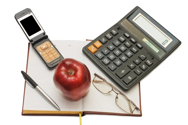 Telefoon, apple en bril op het boek — Stockfoto