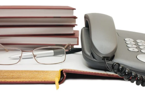 Teléfono y gafas en el libro — Foto de Stock